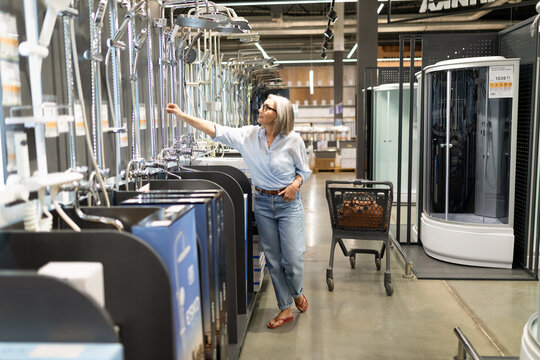 Exploring various shower fixtures in a home improvement store during a weekend afternoon
