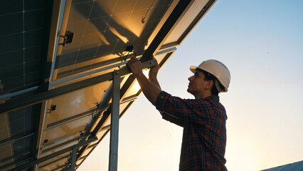 Man installing solar panel on roof