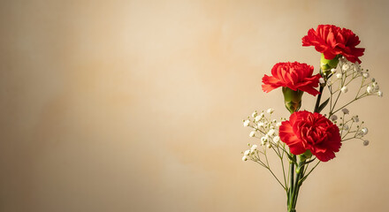Obraz premium Three red carnations with greenery against a beige background