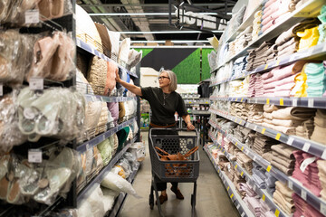 Shopping for home textiles and decor in a modern store during daytime with a focus on style and comfort