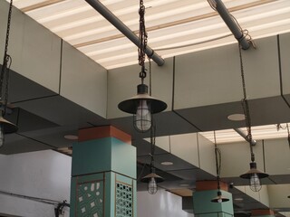industrial pendant light hangging from a modern ceiling structure