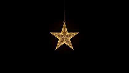Fototapeta premium A gold star ornament hanging from a red string against a black background