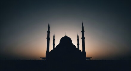 Fototapeta premium Mosque silhouette against soft, glowing sky at dusk