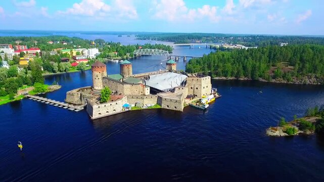 Aerial view of Olavinlinna Medieval Castle in Savonlinna, Finland. Beautiful summer landscape with blue lakes and clear sky