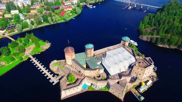 Aerial view of Olavinlinna Medieval Castle in Savonlinna, Finland. Beautiful summer landscape with blue lakes and clear sky