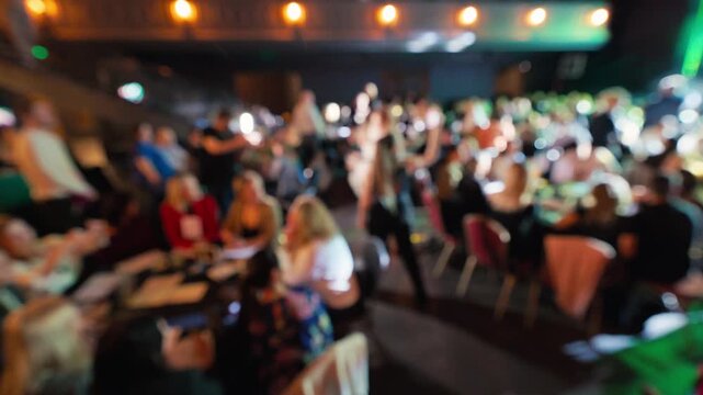 Professionals gather for celebration. Chandelierlit gathering with drinks and presentations