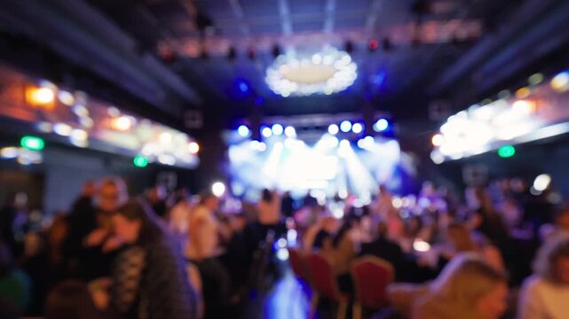 Crowded dance floor with lively energy. People dance energetically amid flashing lights and music