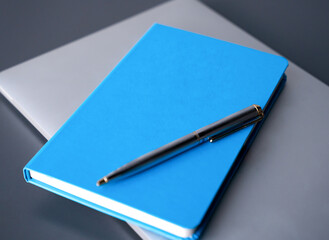 Minimalist composition with a blue notebook for planning, strategy, notes, and modern office concept. Copy space. Selective focus.