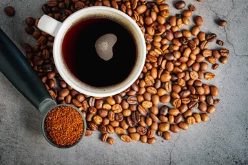 Fototapete Rund Cafe Coffee cup with coffee beans and ground coffee on gray background, Americano cup aromatic top view  © NARONG