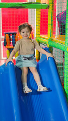 Children's playground. plastic slide. Child in a children's center. High quality photo