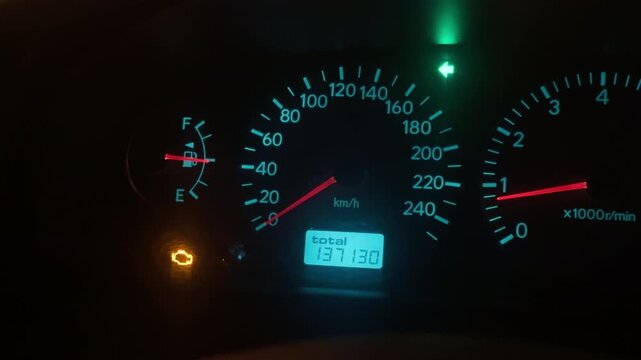 Illuminated vehicle instrument panel displaying speed and tachometer suitable for nighttime footage