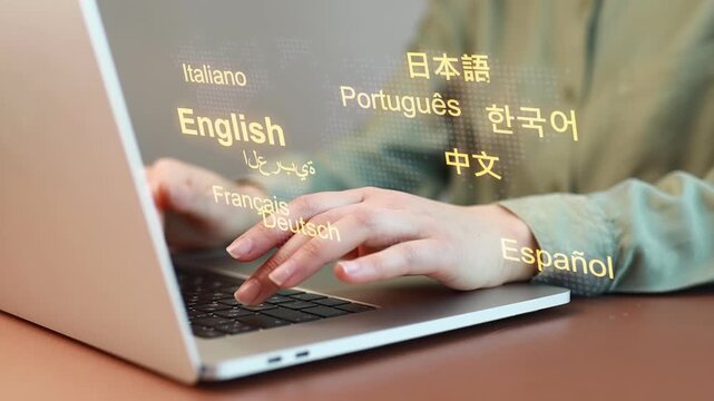 Person types on laptop with multiple languages displayed on the screen in a home office setting during the day.