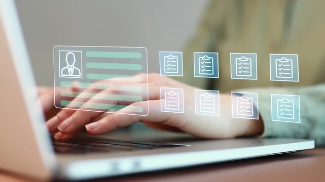 Person uses laptop for document management and data entry work during a normal weekday in an office setting.