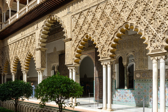 Intricate Mudejar Architecture of the Real Alcazar of Seville Spain featuring Ornate Plasterwork Multifoil Arches and Colorful Tiles at UNESCO World Heritage Palace
