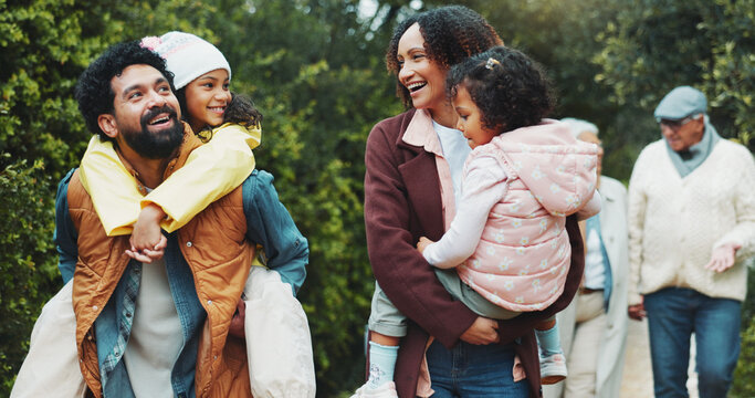 Family, children and walk at park, excited and piggyback with happy for sightseeing, holiday and bonding. People, parents and grandparents with kids, vacation or outdoor together at urban garden