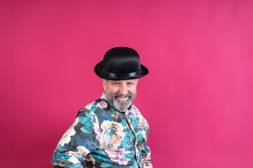 Stylish man wearing bowler hat smiling at camera