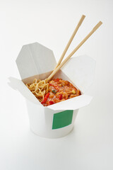 Chinese food takeout box with noodles and sweet sour chicken