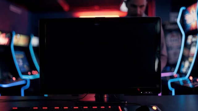 Focused shot of the digital leaderboard reset screen with a blinking prompt while the gaming area behind fades into a gentle blur.