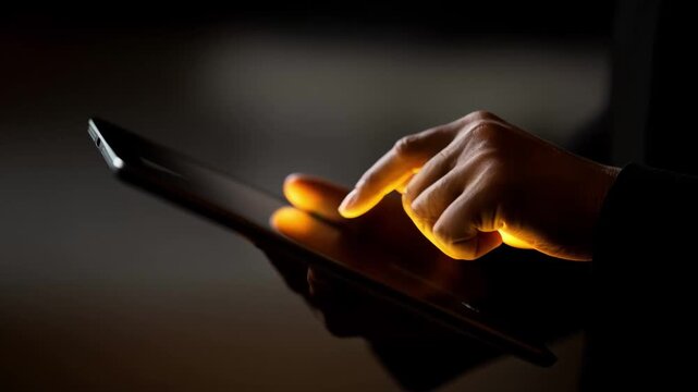 Hands holding an ereader with night mode enabled showcasing a warm eyefriendly screen glow in a dimly lit room.
