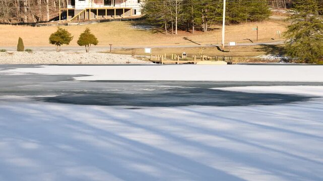 Timelapse shows a frozen lake in Tennessee begins to crack and melt as temperatures rise above freezing.