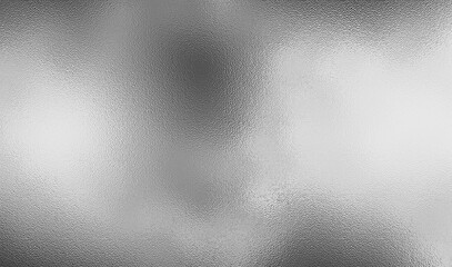 Silver foil metallic texture with glossy gray steel surface. Frosted glass blur effect, soft glare reflections, bright polished metal look. Aluminum or chrome glistening for luxury, tech, design.