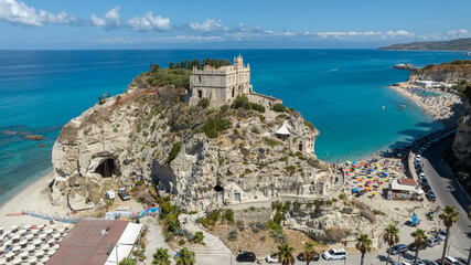 Aerial view of Tropea, a tourist destination in Calabria, southern Italy. At the center of the coast is a high cliff, atop which stands the Church of Santa Maria dell'Isola, the main attraction. © Stefano Tammaro