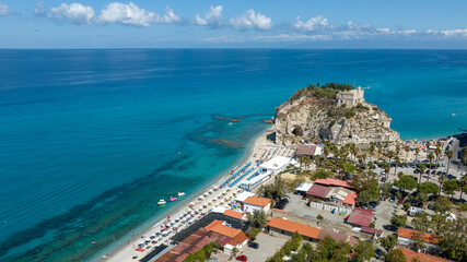 Aerial view of Tropea, a tourist destination in Calabria, southern Italy. At the center of the coast is a high cliff, atop which stands the Church of Santa Maria dell'Isola, the main attraction. © Stefano Tammaro