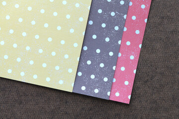 three sheets of crafting paper with dots