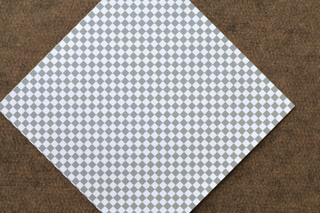 paper square with grid on brown board