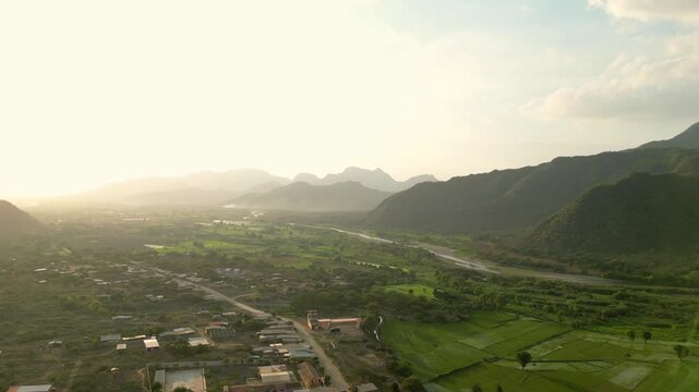 AERIAL DRONE VIDEO OF A SCENIC VALLEY IN CHICLAYO, PERU, FEATURING AGRICULTURAL FIELDS, RIVER LANDSCAPES, AND MOUNTAIN VIEWS