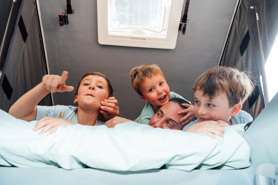 Family enjoying morning in camper van rooftop tent
