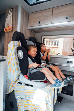 Children traveling in camper van during family road trip