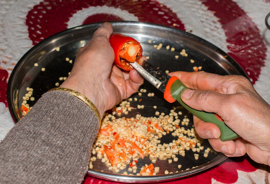 removing seeds of red chilli for making lal mirch ka achar or pickle. traditional way of making pickle in Indian kitchen.