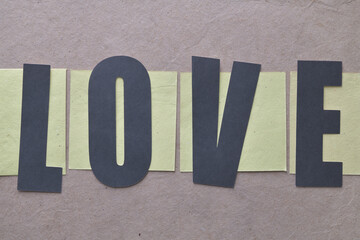 the word love on yellow cards and brown textured paper