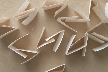 edge up folded paper shapes viewed top down on brown paper
