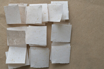 folded paper pieces arranged in checkered form on brown