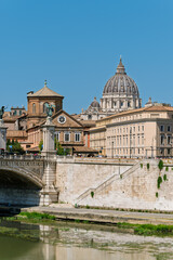 Fototapeta premium Italy - Rome - Tiber River - Sant'Angelo Bridge creates perfect reflection pathway leading to Vatican's iconic basilica dome