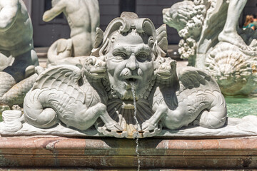 Obraz premium Italy - Rome - Piazza Navona - Fontana del Moro features dramatic grotesque mask with serpentine fish tail in marble detail