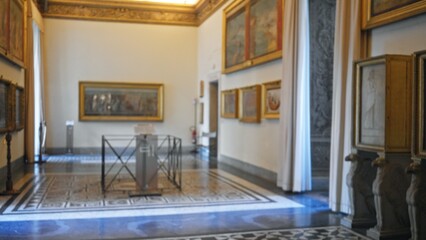 Blurred museum interior with shallow bokeh focusing on ornate tiled floor, framed paintings and marble columns  background backplate copyspace calm. © Krakenimages.com