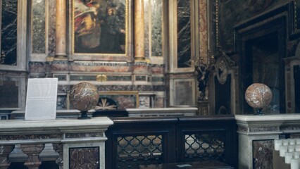 Ornate church interior with marble balustrade, stone columns and framed altar, shallow defocused bokeh background  background copyspace backplate. © Krakenimages.com