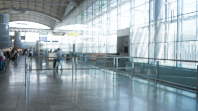 Blurred airport terminal interior with shallow bokeh and soft defocus; background backplate template calm.