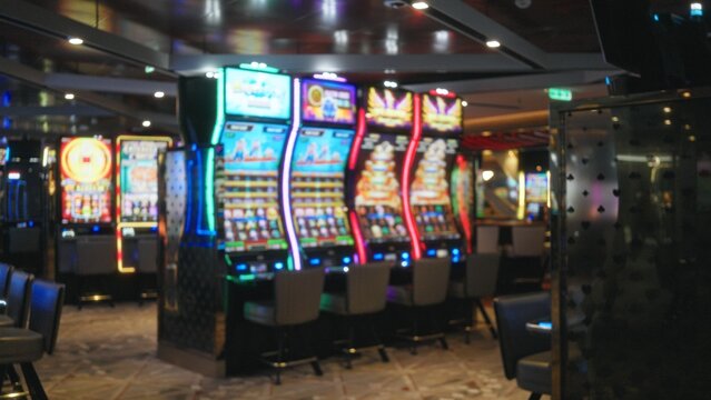 Blurred neon slot machines and seating in soft bokeh interior; background backplate backdrop template.