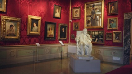 Museum gallery interior with defocused bokeh on framed paintings and central statue  background backdrop copyspace calm. © Krakenimages.com