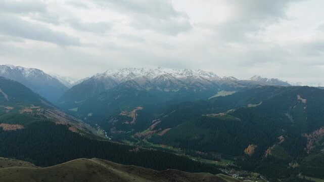 Flying Towards Tian Shan near Karakol under overcast Sky in Autumn