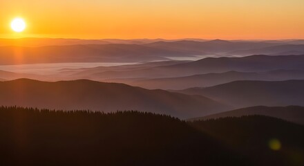 Obraz premium Sunset over mountain landscape with golden light reflecting on hills