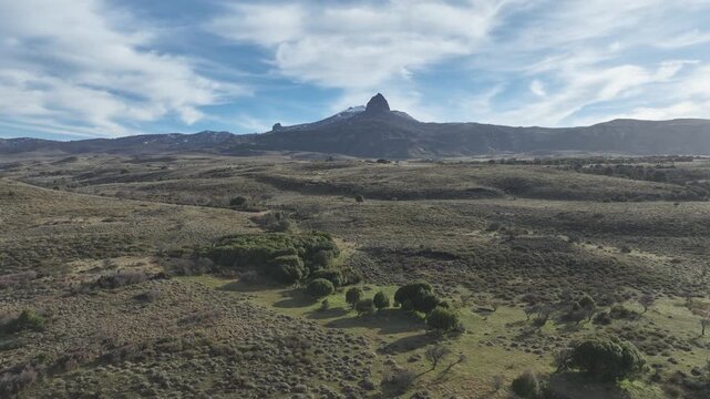 Striking Pointed Mountain Peak Rising Above a Vast Dry Steppe Landscape. Lanin National Park, Argentina