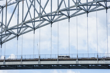Fototapeta premium Close-up of the suspended roadway of the Bridge of the Americas with vehicles driving across near the Panama Canal in Panama
