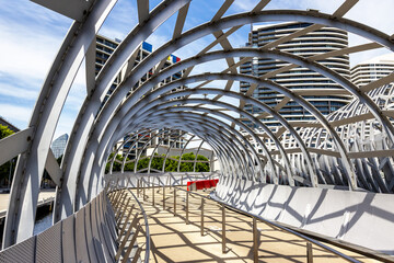 Fototapeta premium The unique and iconic Webb Bridge, Melbourne, Australia. This contemporary structure spans the Yarra River and is a pedestrian and cycle path linking the Docklands and South Bank.