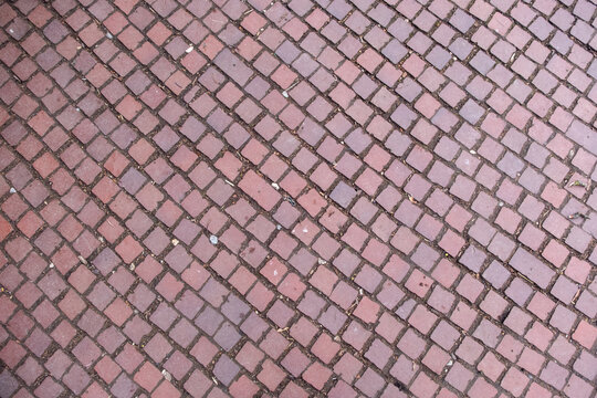 A brick walkway with a pattern of squares