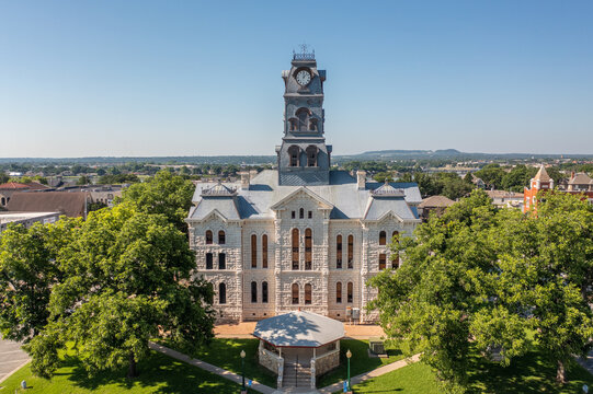 Aerial Drone View of Courthouse Official Building With Clock Tower in Town Square of Downtown Granbury, Texas